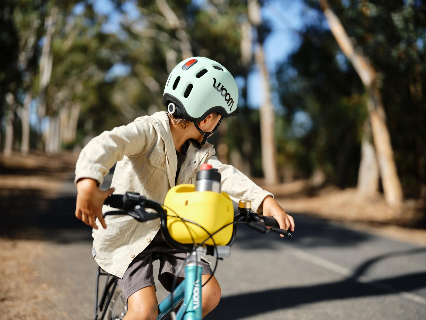 Een kind kijkt achterom op een fiets met een blauwe READY-fietshelm op.